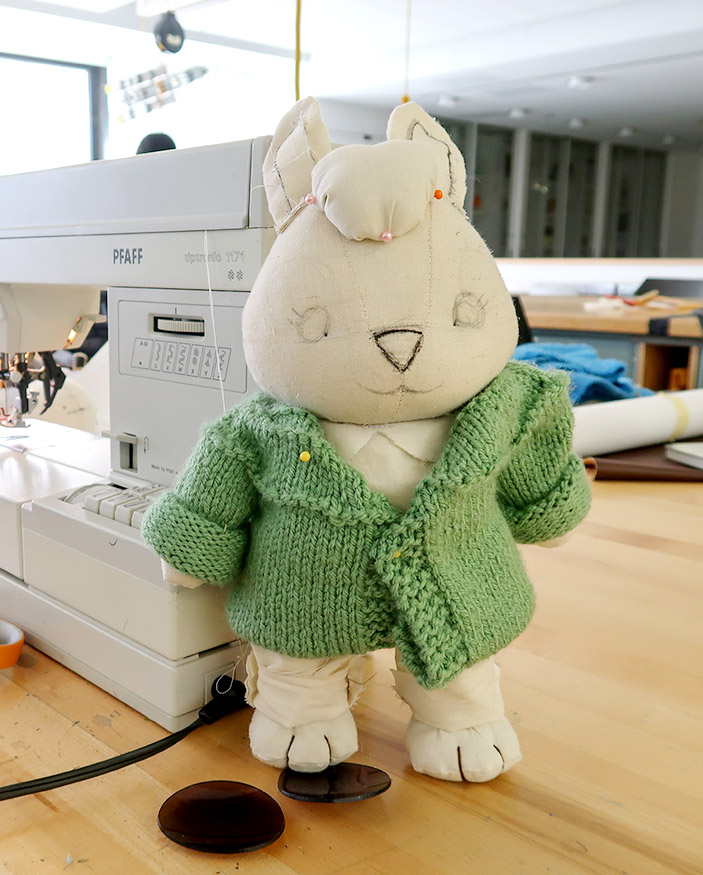 stuffed toy bunny created by FIT student on table next to sewing machine