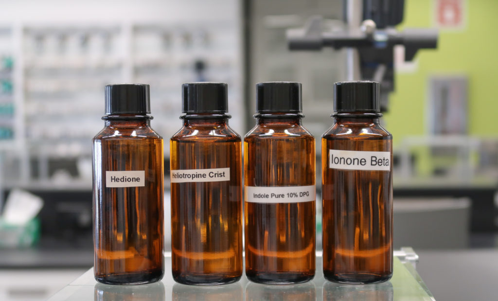 brown bottles on glass table in FIT's Fragrance Studio
