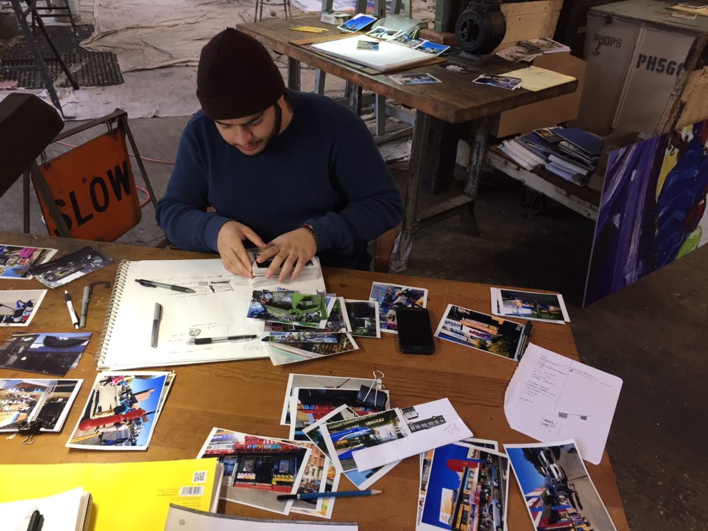 student at table sorting through photographs