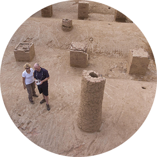 man and woman surveying old structures of excavated brewery site