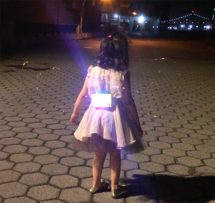 girl with led light pack on back and wire wings